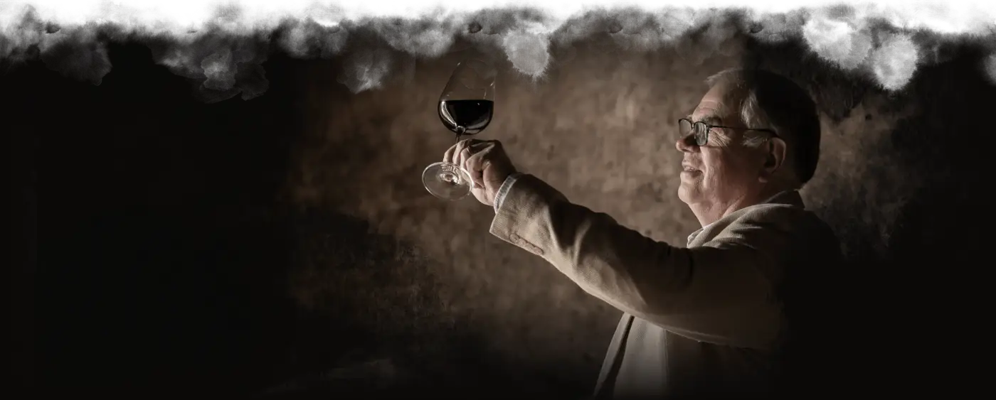Winemaker Gary Baumgarten raising a glass of Sieraad against the light